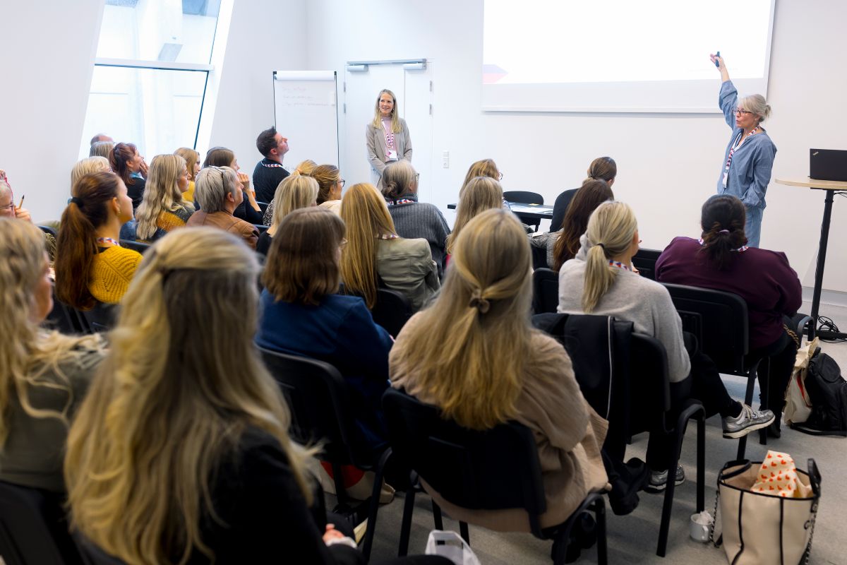 En person peger på storskærm foran en masse tilhører. Billedet er fra Lægedage 2024. Foto af Claus Boesen